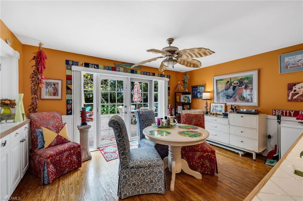 Dining space featuring french doors, ceiling fan, and light wood-type flooring
