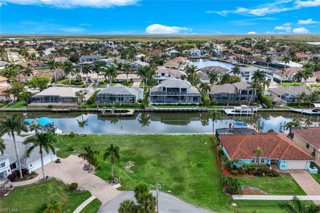 Aerial perspective of suburban area featuring a large body of water
