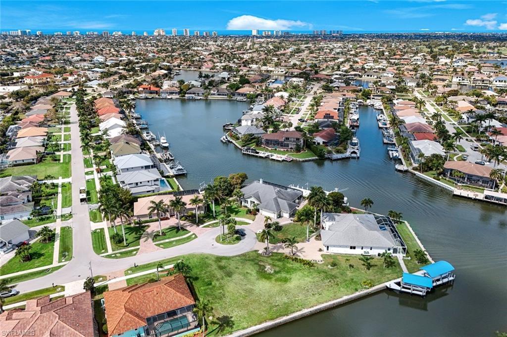 Aerial perspective of suburban area featuring a large body of water