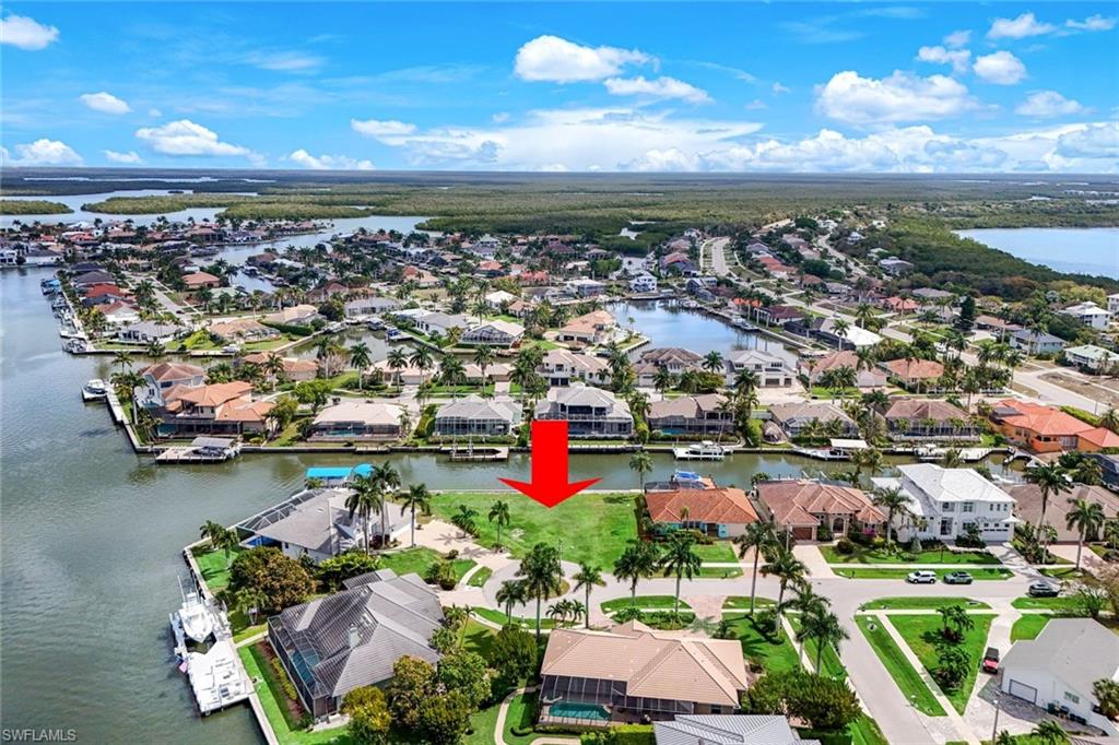 Aerial view of residential area featuring a large body of water