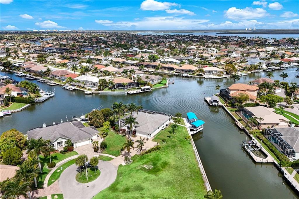 Aerial view of residential area featuring a large body of water