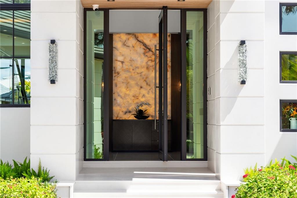 View of exterior entry with stone siding and stucco siding