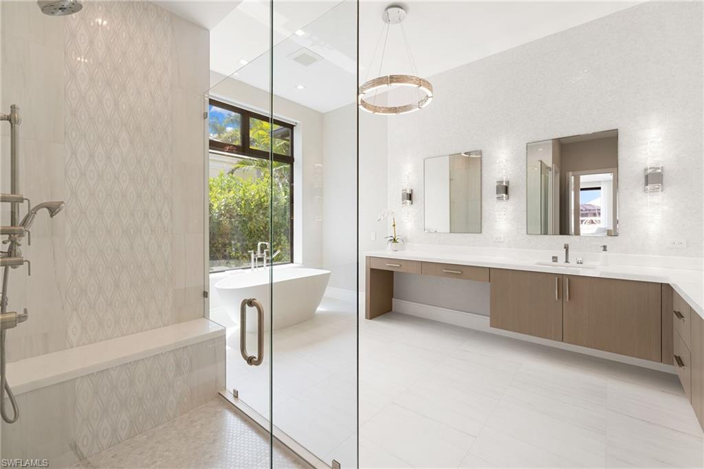 Full bathroom with vanity, tiled shower, a soaking tub, and recessed lighting