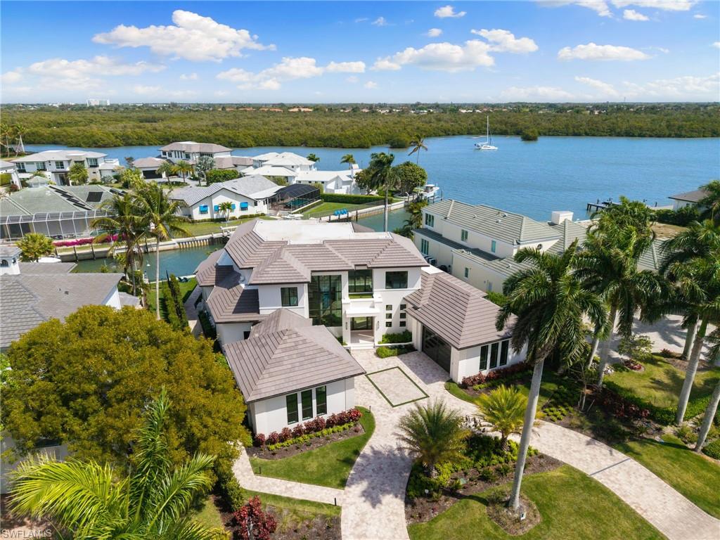 Aerial perspective of suburban area featuring a large body of water
