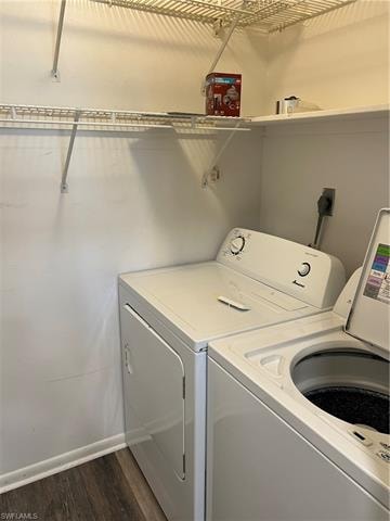 Laundry room with separate washer and dryer and dark wood-style floors