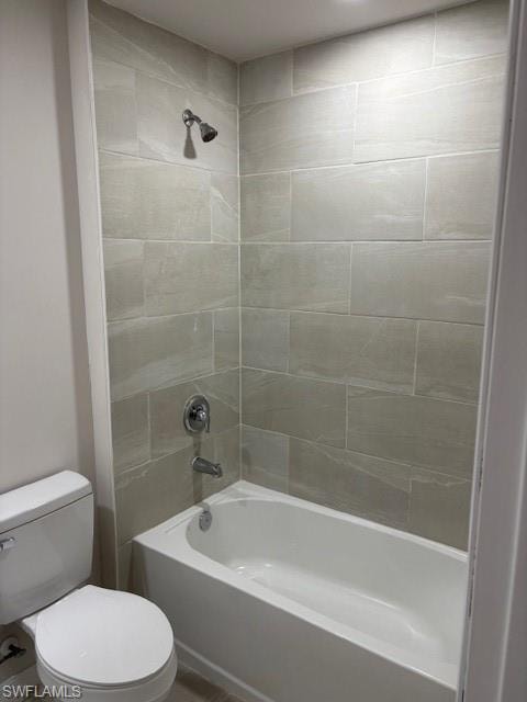 Bathroom featuring bathtub / shower combination and toilet