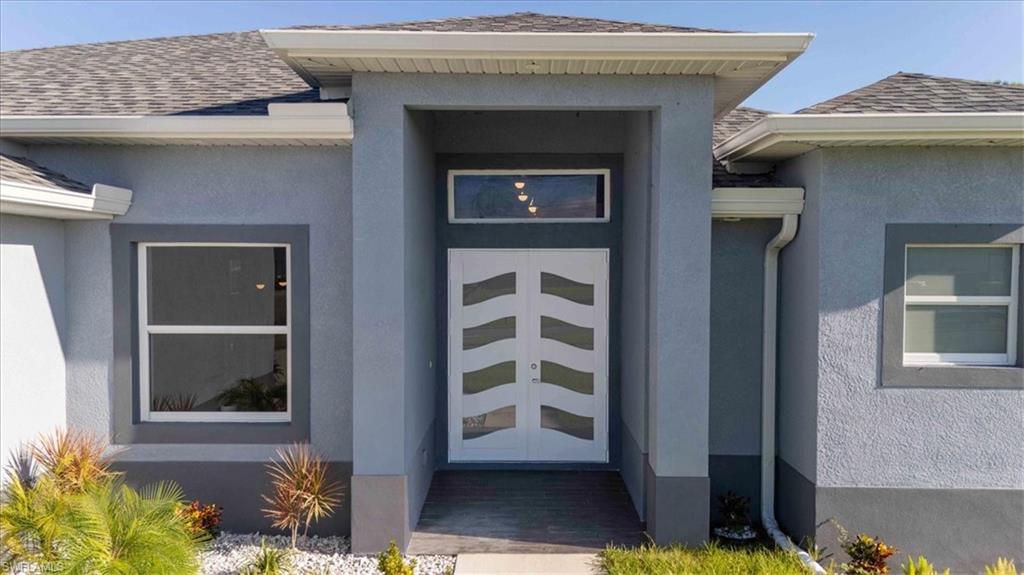Back of house featuring a fenced backyard, a ceiling fan, a patio, and stucco siding