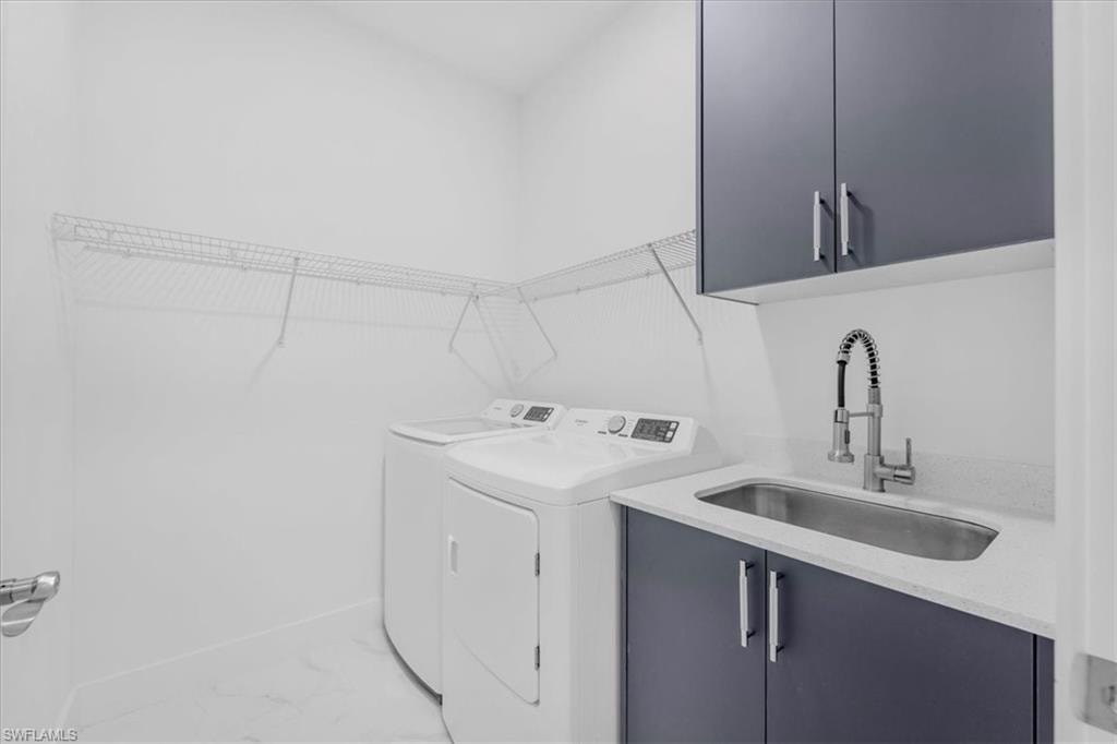 Laundry room with cabinet space and washer and clothes dryer