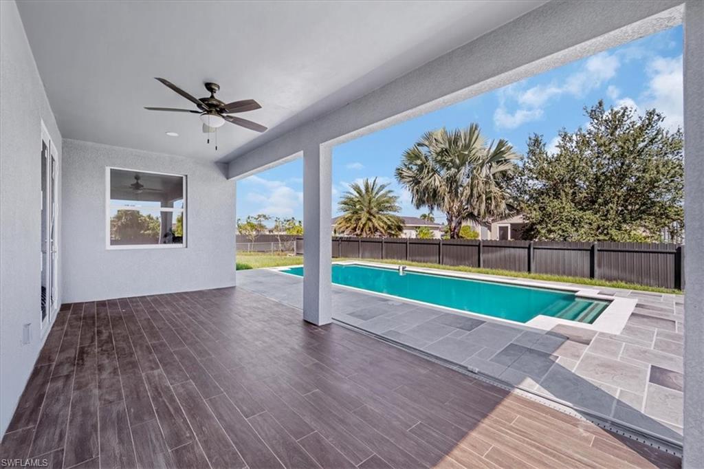View of pool with patio surround and a fenced backyard