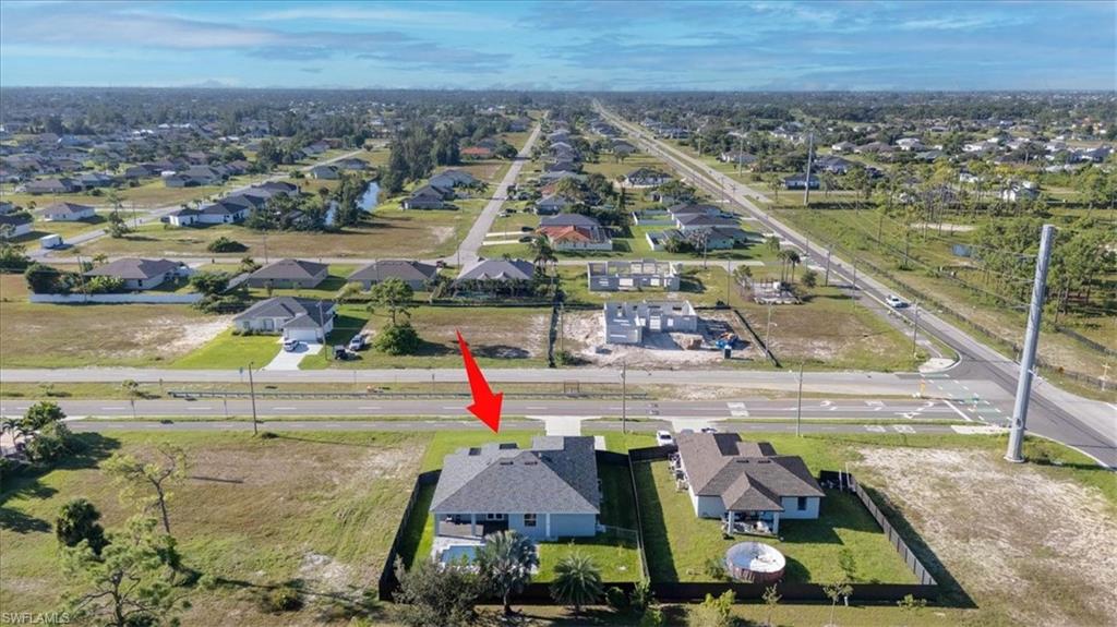 Aerial view of property's location featuring nearby suburban area