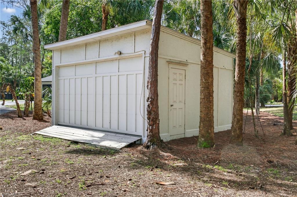 Additional storage building with garage door.
