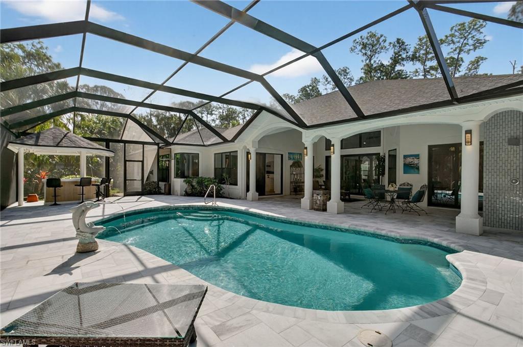 Brand new pool cage, tiki bar, fountain, outdoor shower, and 1/2 bath!