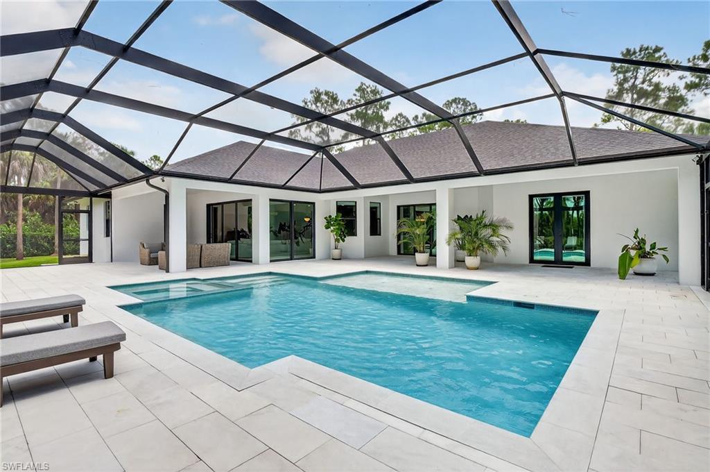 Outdoor pool with a sunroom, a patio area, a lanai, and french doors