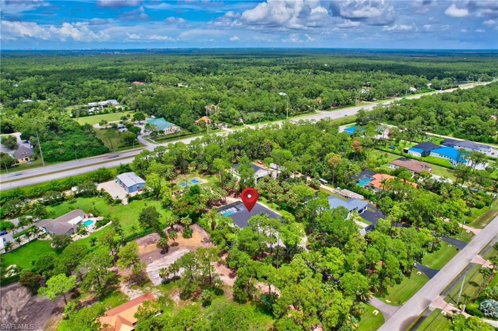 Aerial perspective of suburban area with a forest