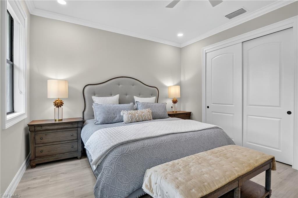 Bedroom featuring light wood finished floors, crown molding, a closet, ceiling fan, and recessed lighting