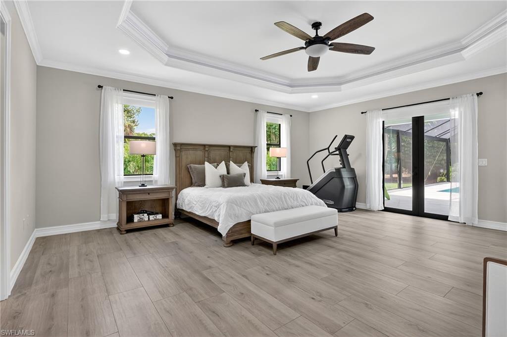 Bedroom featuring crown molding, access to exterior, light wood-type flooring, a ceiling fan, and recessed lighting