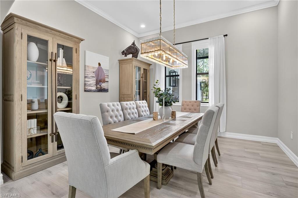 Dining space featuring ornamental molding, light wood-type flooring, and recessed lighting