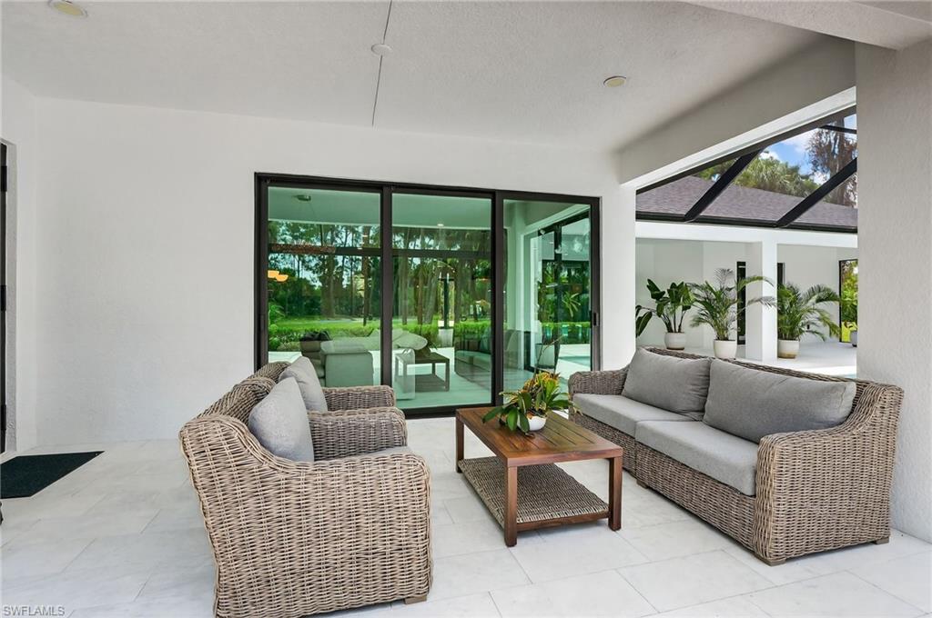 View of patio / terrace with an outdoor living space, a sunroom, and a lanai