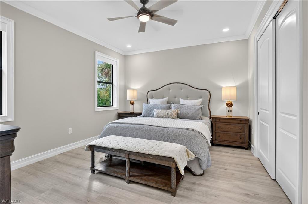 Bedroom with ornamental molding, a closet, light wood-style floors, recessed lighting, and a ceiling fan