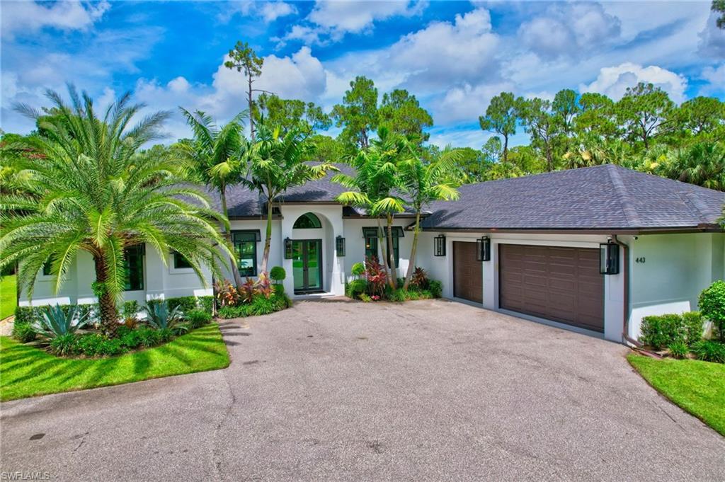 View of front of home with roof with shingles, an attached garage, stucco siding, and asphalt driveway