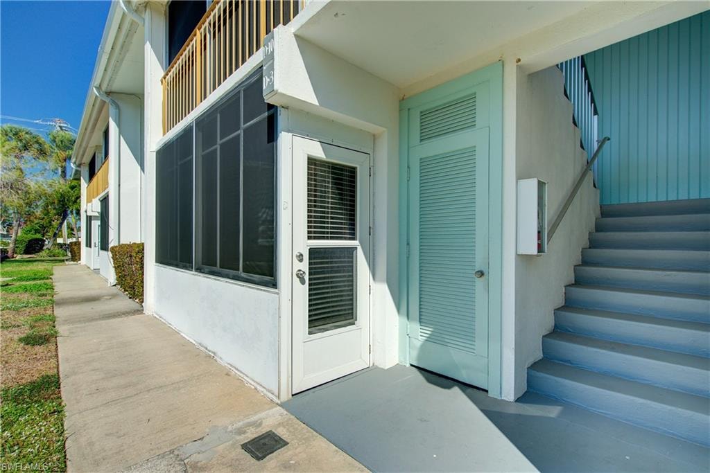 Door leading out of sun room, shared storage area with room for bikes etc.