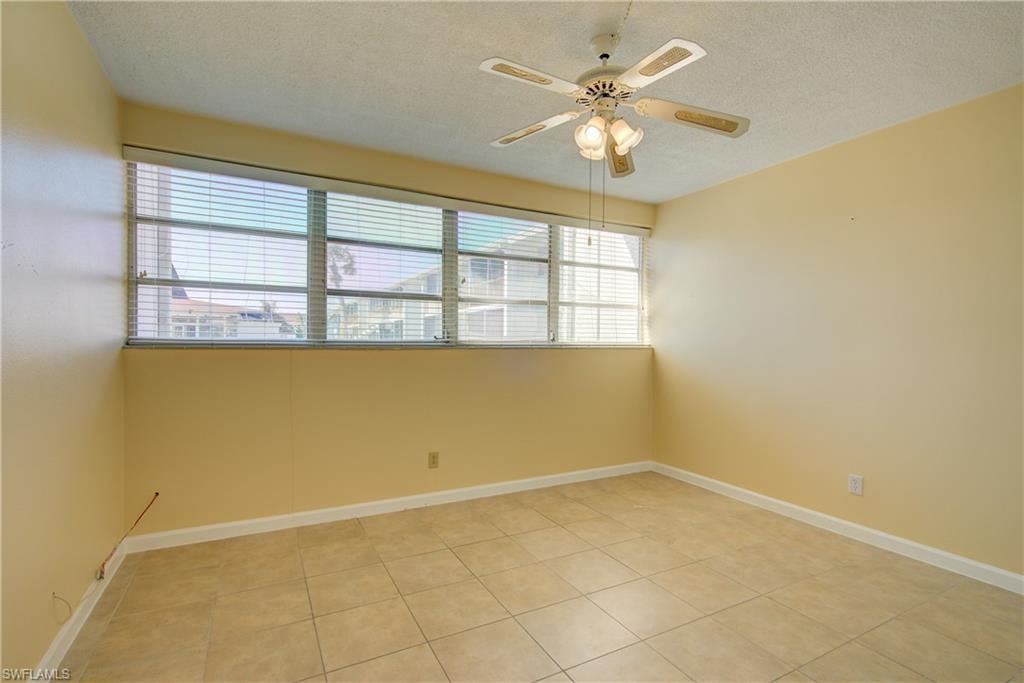Primary Bedroom featuring ceiling fan, and light tile patterned floors