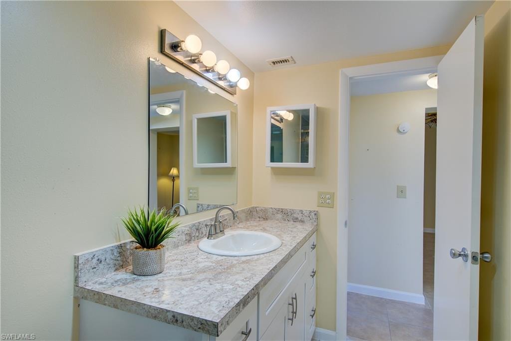 Bathroom with vanity and light tile patterned flooring