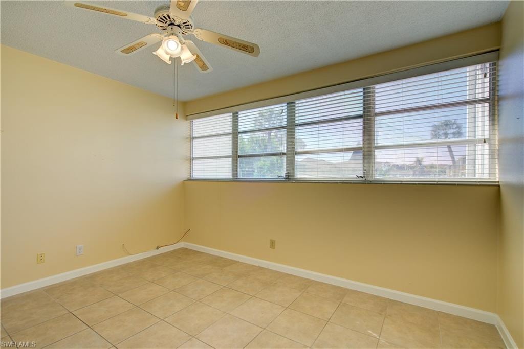 Primary Bedroom with a ceiling fan, and light tile patterned flooring