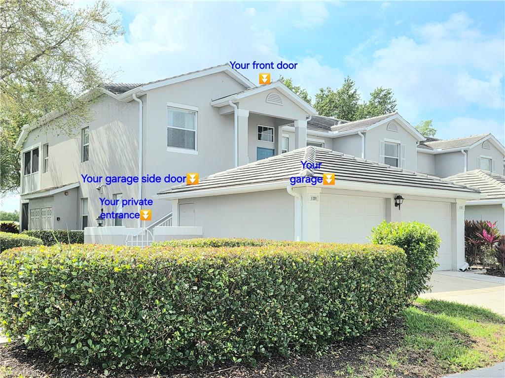 View of front facade featuring a garage, stucco siding, and driveway