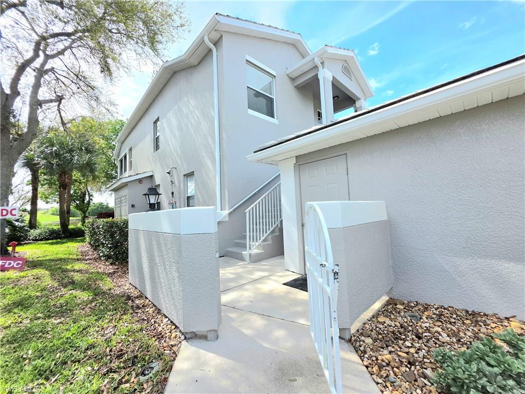 View of side of property featuring stucco siding