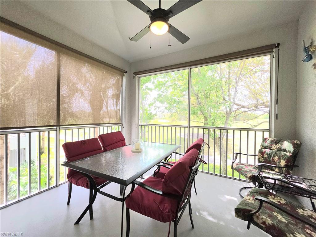 Sunroom featuring ceiling fan, outdoor dining area, and a balcony