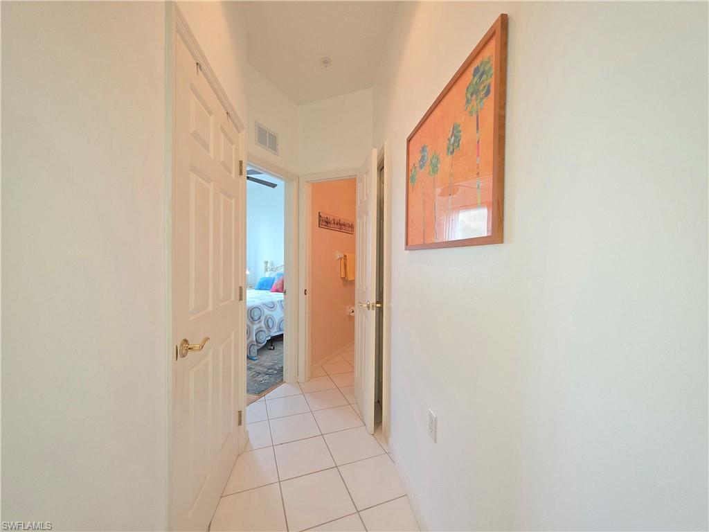 Hallway with light tile patterned floors