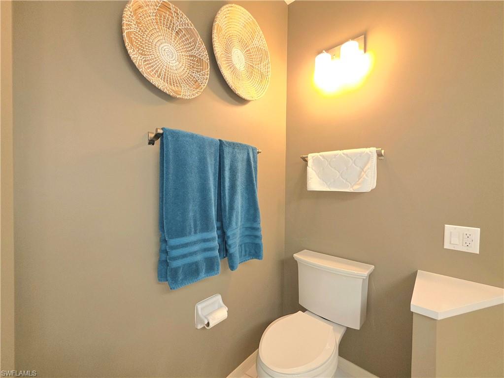 Bathroom featuring toilet and baseboards