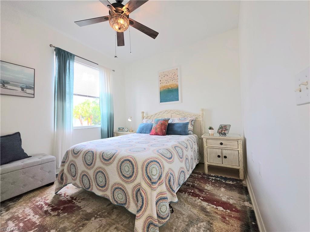 Bedroom featuring ceiling fan and baseboards
