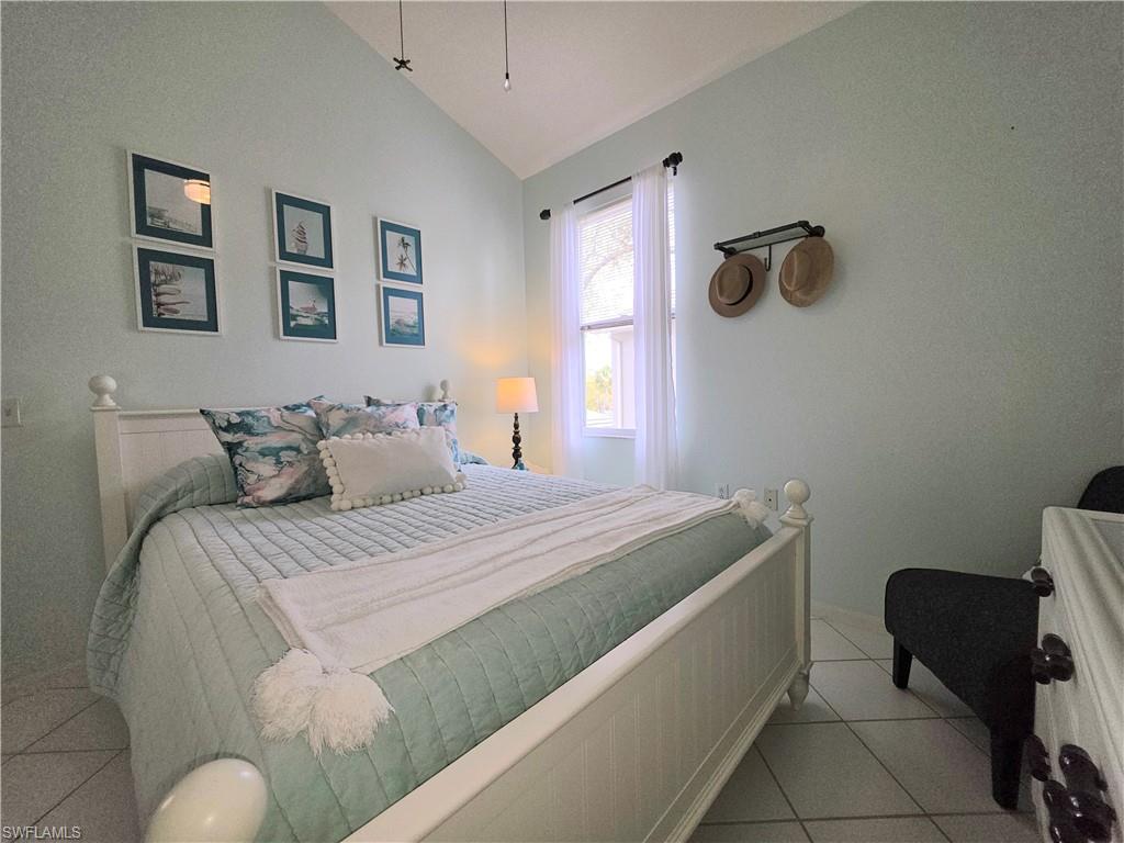 Bedroom featuring vaulted ceiling and light tile patterned floors
