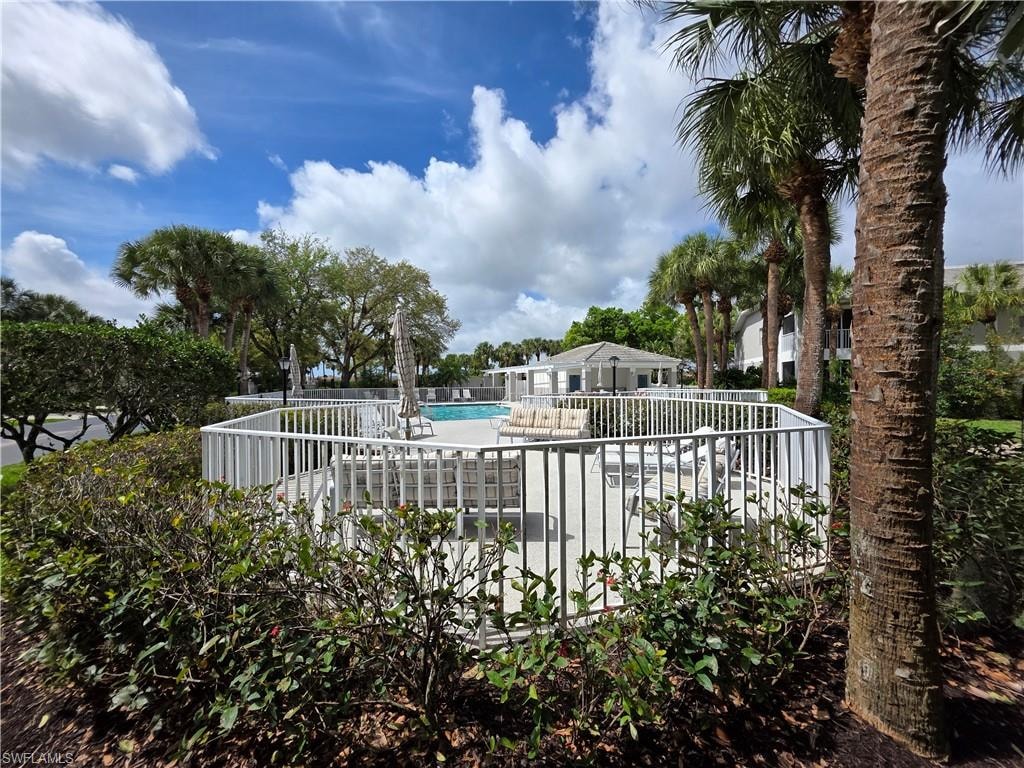 Community pool with a patio area and a deck