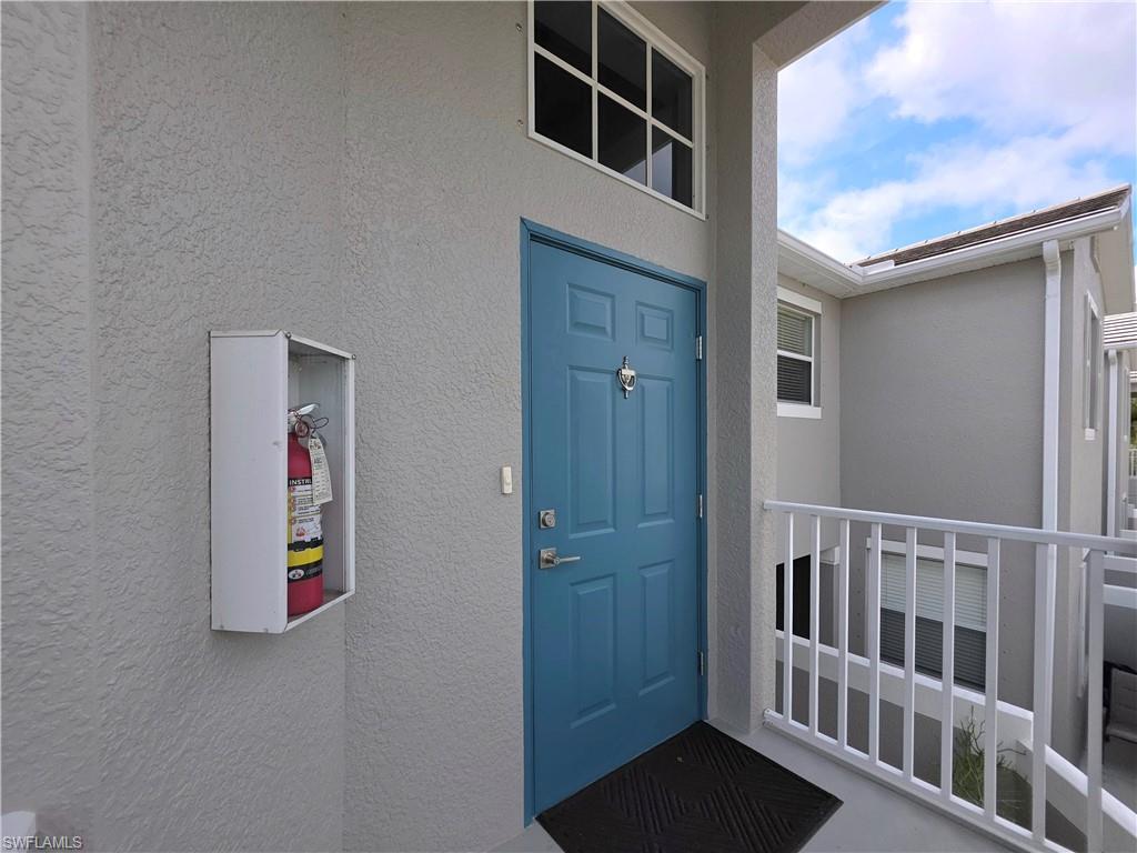 Doorway to property with stucco siding