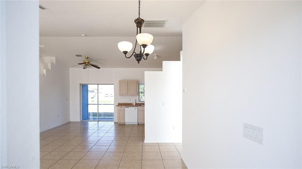 Entry room with light tile patterned floors, hanging lights, and ceiling fan