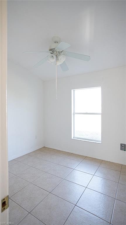 Spare room with a ceiling fan and light tile patterned flooring
