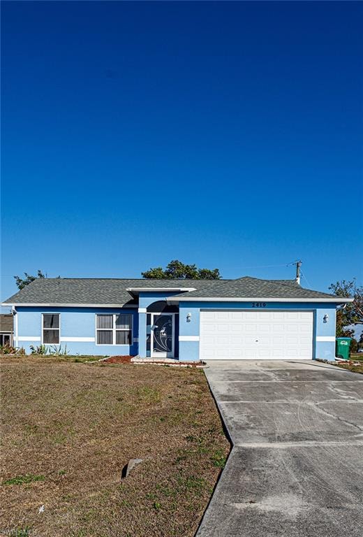 Ranch-style home featuring driveway, an attached garage, a front yard, a shingled roof, and stucco siding