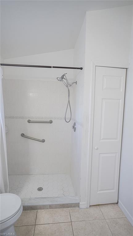 Bathroom with a stall shower and light tile patterned floors