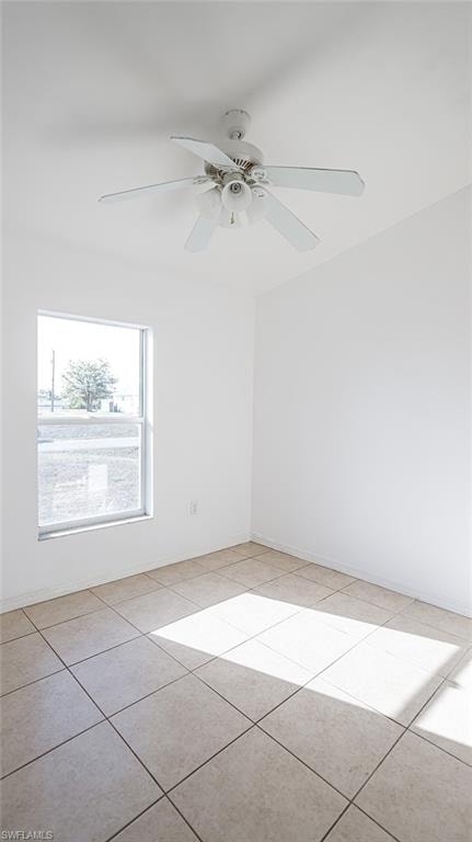 Unfurnished room featuring a ceiling fan and light tile patterned flooring