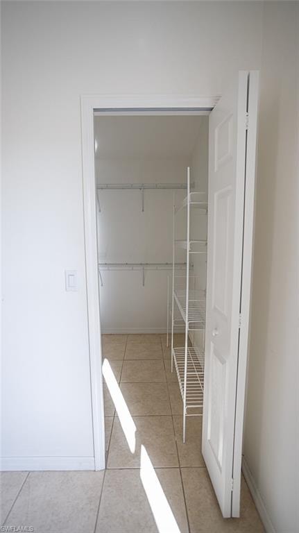 Walk in closet featuring light tile patterned floors
