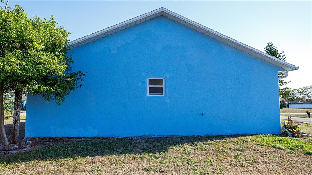 View of property exterior with a lawn