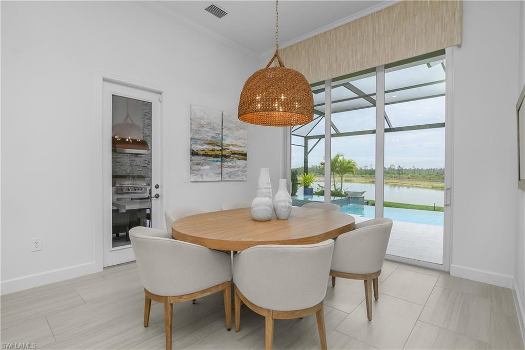 Dining room with baseboards and crown molding
