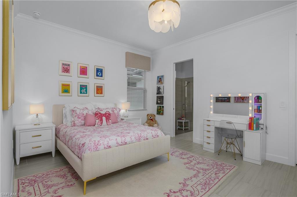 Bedroom with crown molding and baseboards