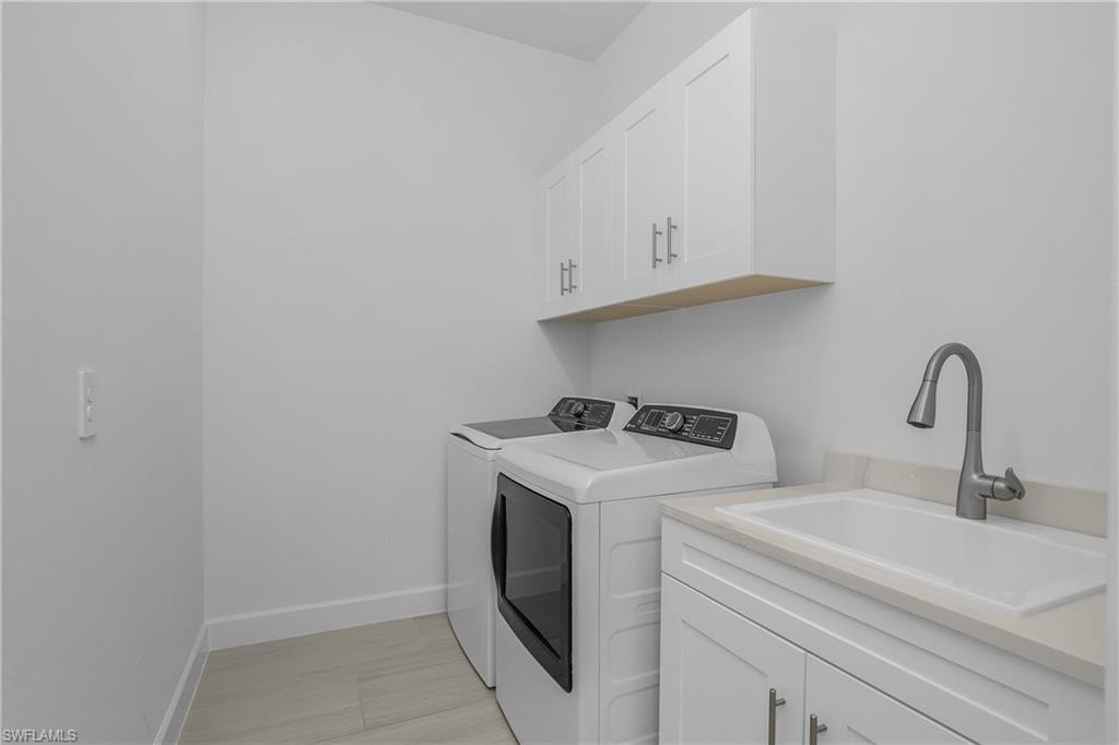 Laundry room featuring cabinet space and washer and dryer