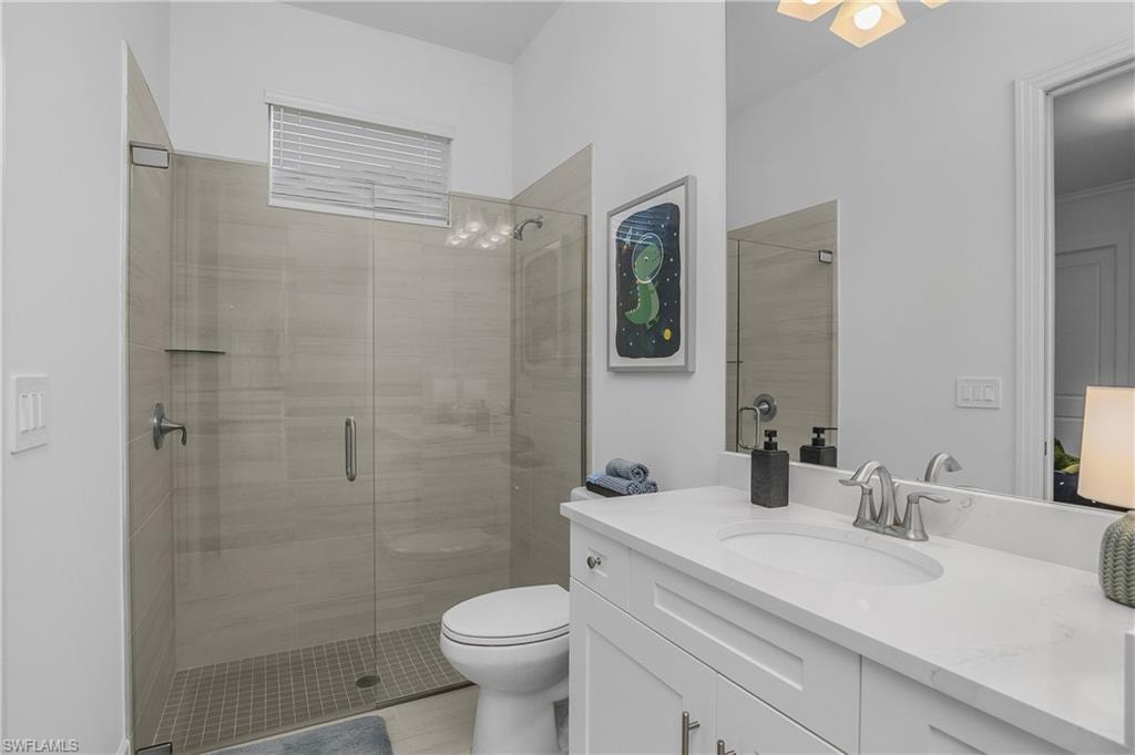 Full bath featuring vanity and a shower stall
