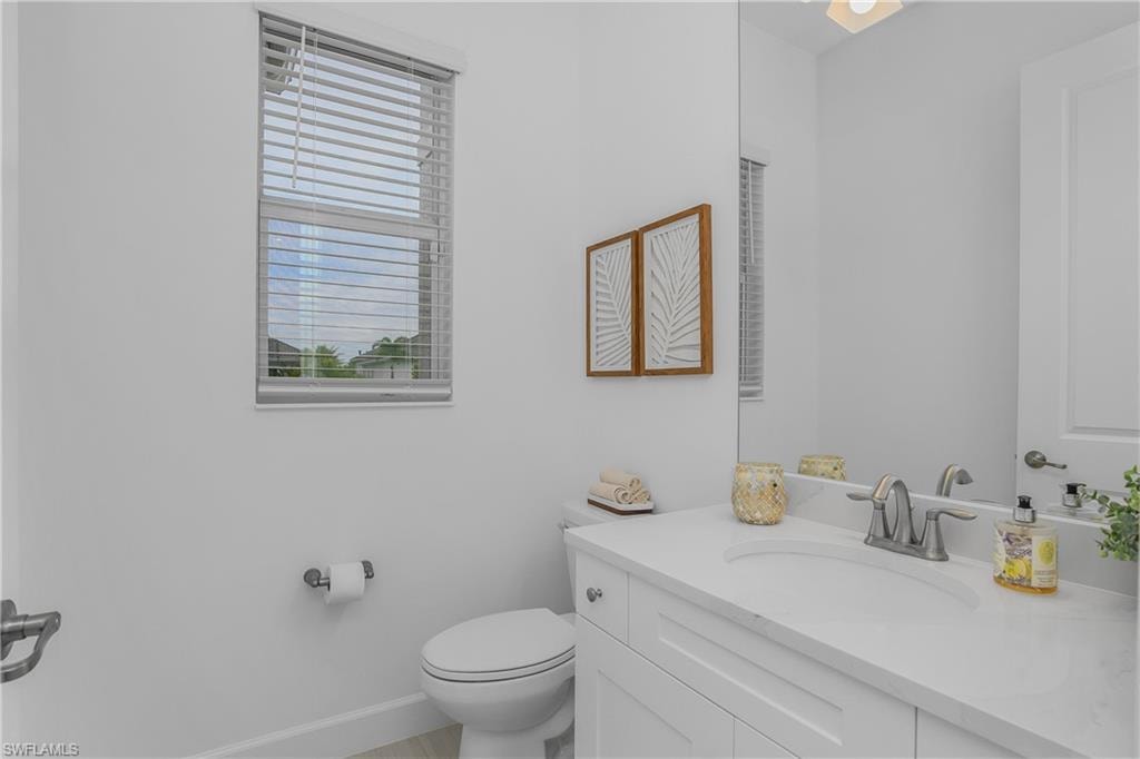 Half bath featuring vanity and toilet
