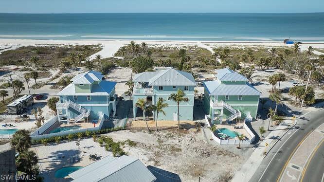 Bird's eye view featuring a water view and a beach view